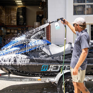Jetski covered in light foam wash, breaking down salt for a deep clean.