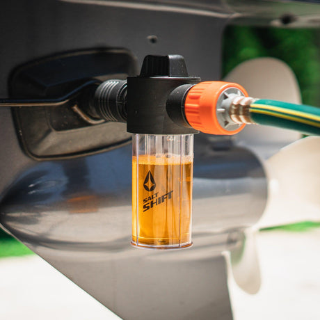 A Salt Shift engine flush system connected to a boat motor for cleaning.