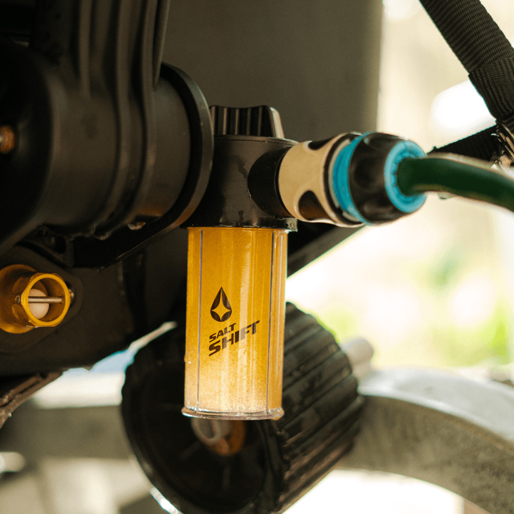 A Salt Shift engine flush system connected to a boat motor for cleaning.
