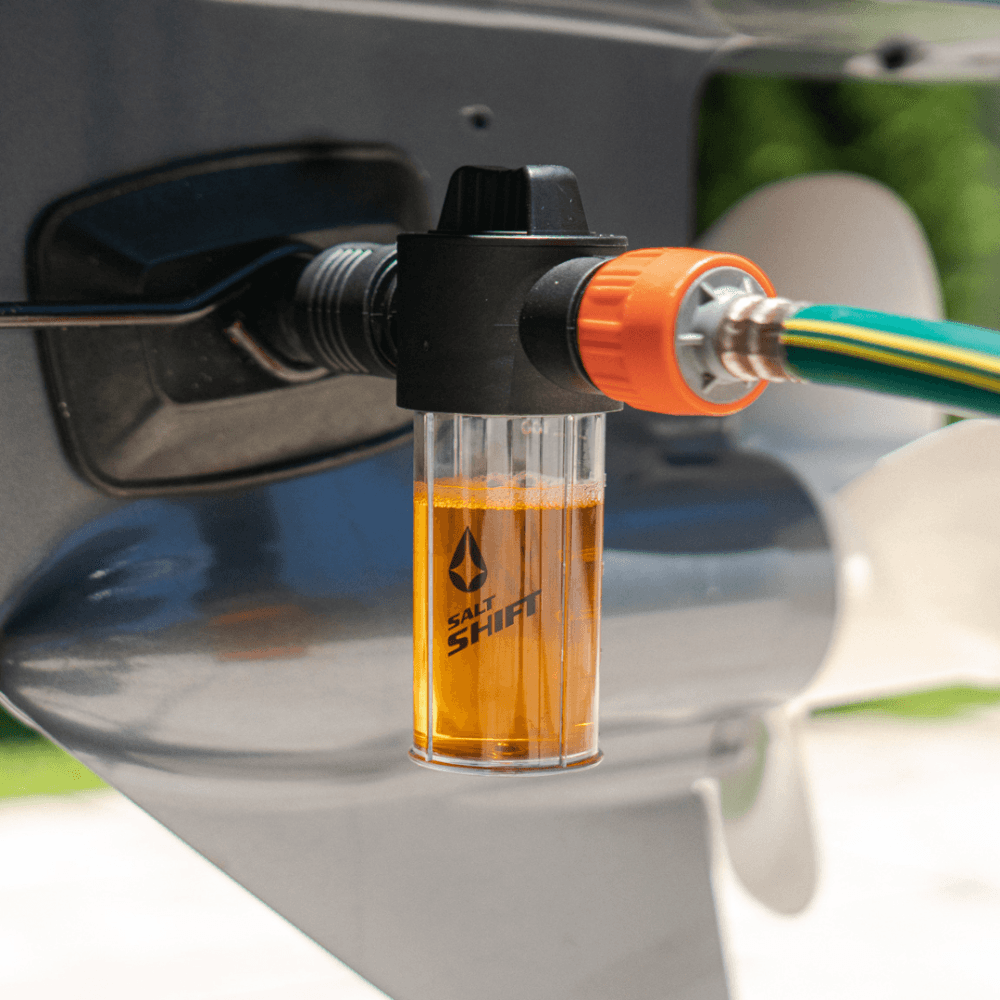 A Salt Shift engine flush system connected to a boat motor for cleaning.