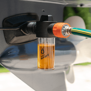 A Salt Shift engine flush system connected to a boat motor for cleaning.