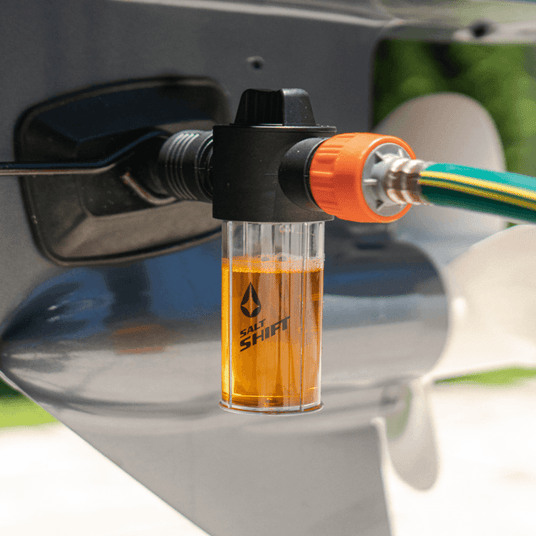 A Salt Shift engine flush system connected to a boat motor for cleaning.