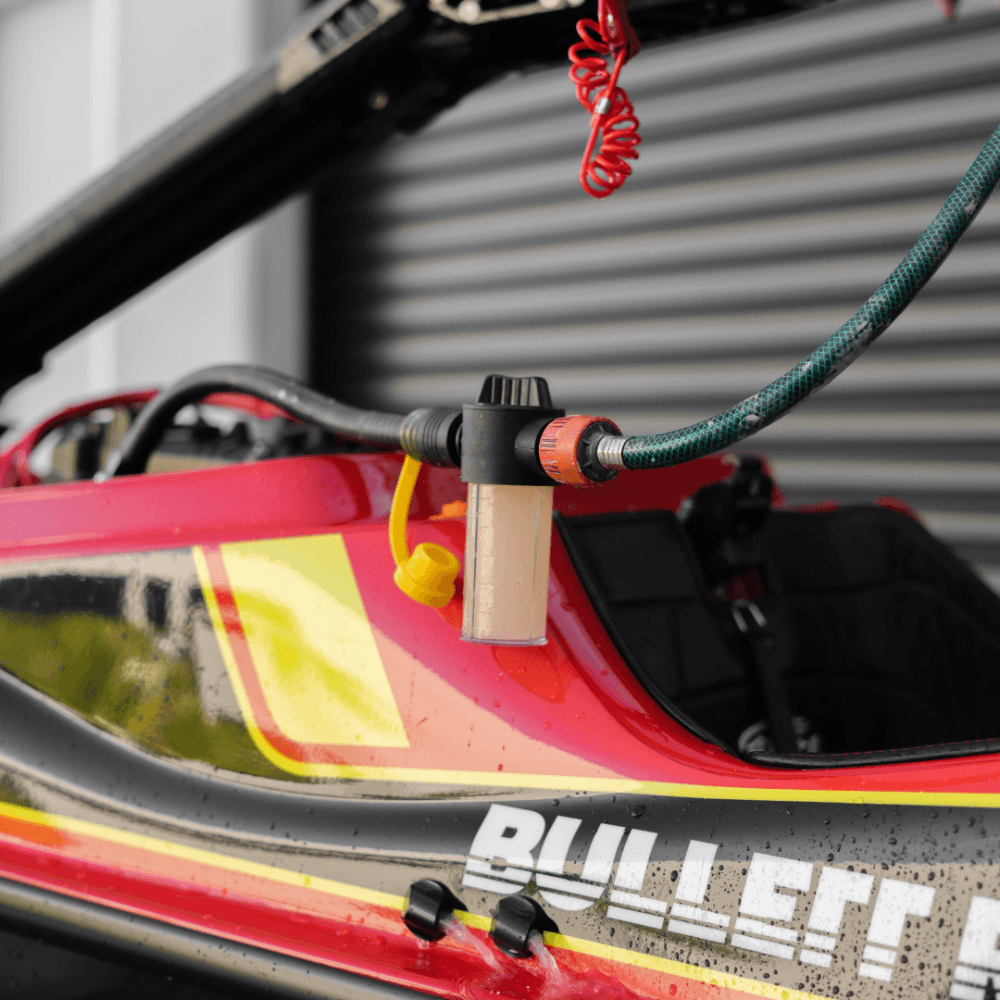 A Salt Shift engine flush system connected to a jetski motor for cleaning.