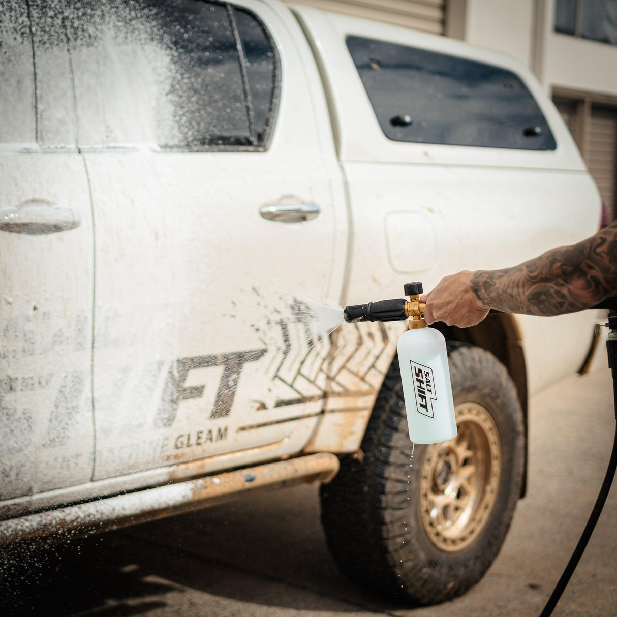 4x4 being covered in thick foam wash, breaking down dirt and grime for a deep clean.