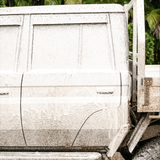 4WD ute covered in thick foam wash, breaking down dirt and grime for a deep clean.