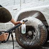 4x4 covered in thick foam wash, breaking down dirt and grime for a deep clean.