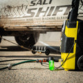 A Salt Shift underbody washer in action, blasting dirt off a 4x4 chassis.