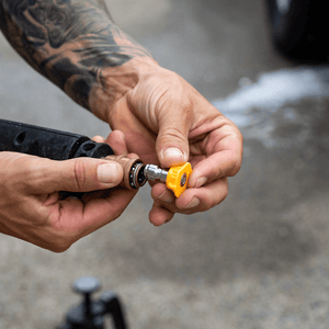 man showing upclose a Salt Shit Quick Release Nozzle 