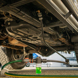 A Salt Shift chassis flusher connected to a 4x4 undercarriage for deep cleaning.